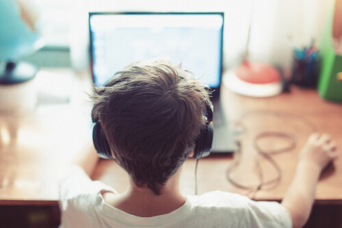 back of child's head watching a computer